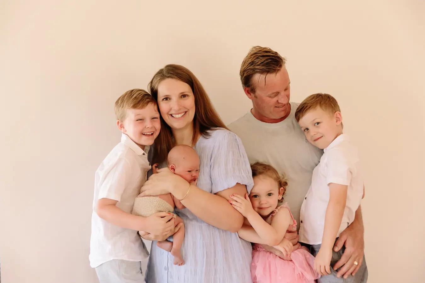Courtney, her husband and their four children together, the youngest a newborn